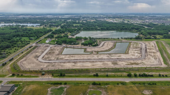Photo from drone of Addis Woods construction progress. Streets and lots are leveled.